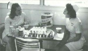 A black and white image of two waitresses. 