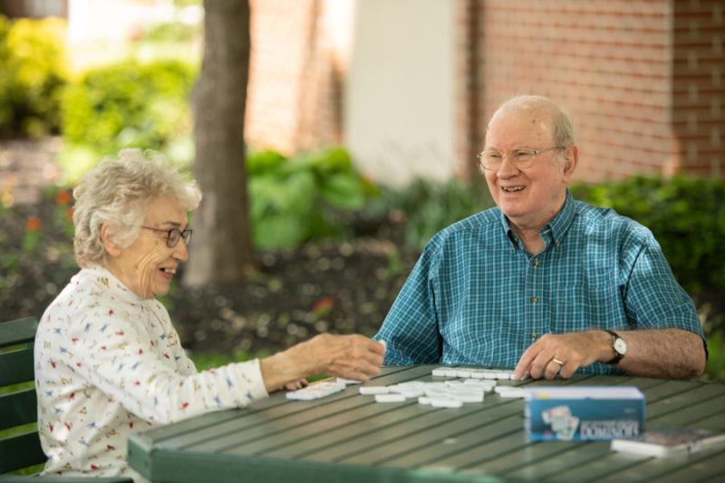 Residents playing dominoes at one of Landis Homes picnic areas.